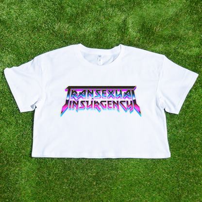 White crop tee with 'Transsexual Insurgency' text on a grass background