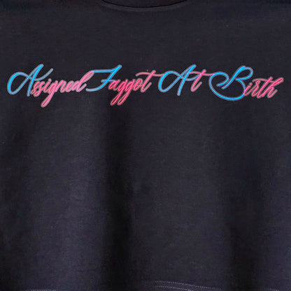 AFAB - locally printed crop tee: Black shirt with "Assigned Fagget At Birth" in pink and blue cursive text.