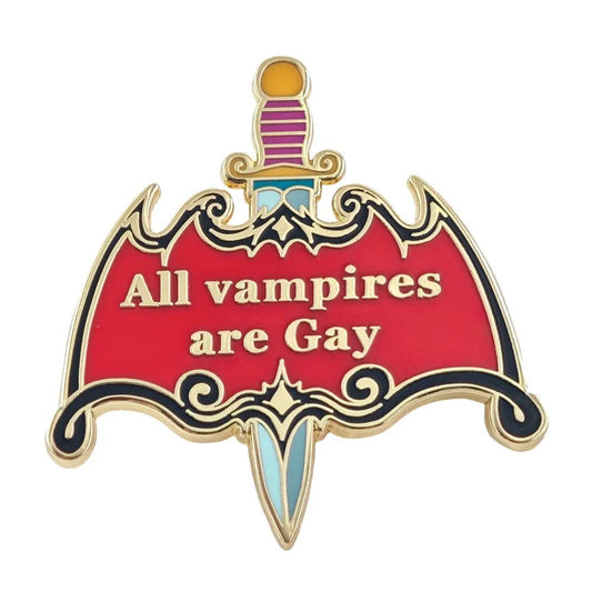 A gold-outlined enamel pin called “All Vampires Are Gay - dagger enamel pin” features a red bat with the phrase “All vampires are Gay” written on it and a colorful dagger piercing through the design.