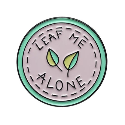 Circular badge with 'Leaf Me Alone' text and leaf illustrations 