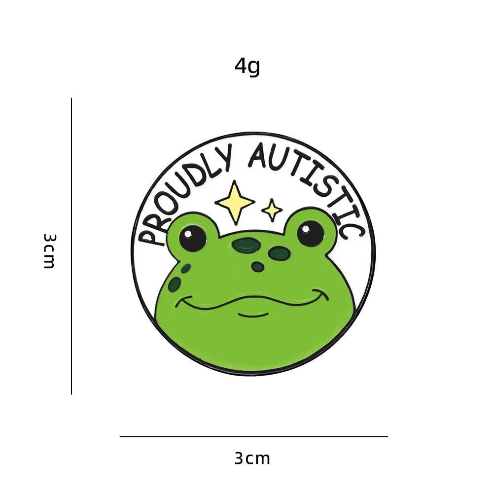 Green frog pin with 'Proudly Autistic' text on a white background