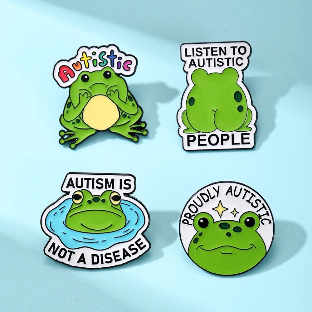 Four green frog-themed pins with autism awareness messages 