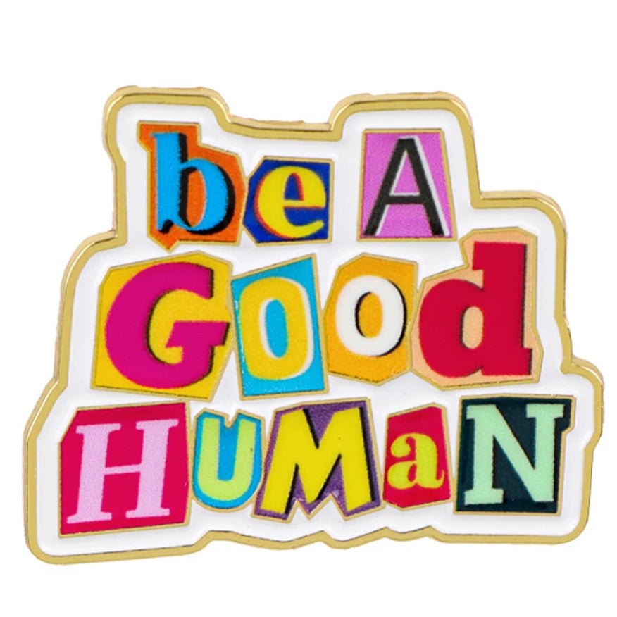 Colorful enamel pin with 'be a good human' text on a white background