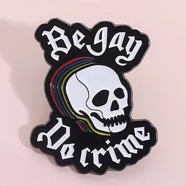 Skull design with 'Be Gay, Do Crime' enamel pin