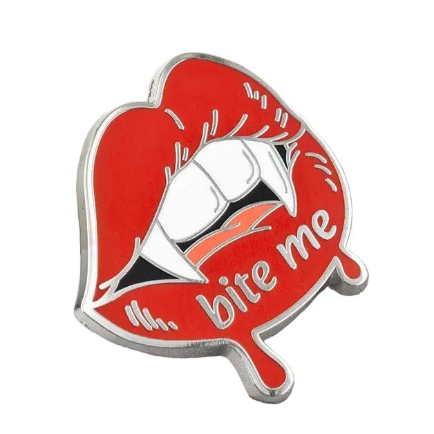 A red enamel pin shaped like lips with white teeth and the words 'bite me' in silver script