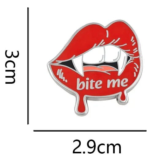 A red enamel pin shaped like vampire lips with fangs and the words 'bite me,' shown on a white background with dimension lines and text indicating 3 cm height, 2.9 cm width, and weight 6.