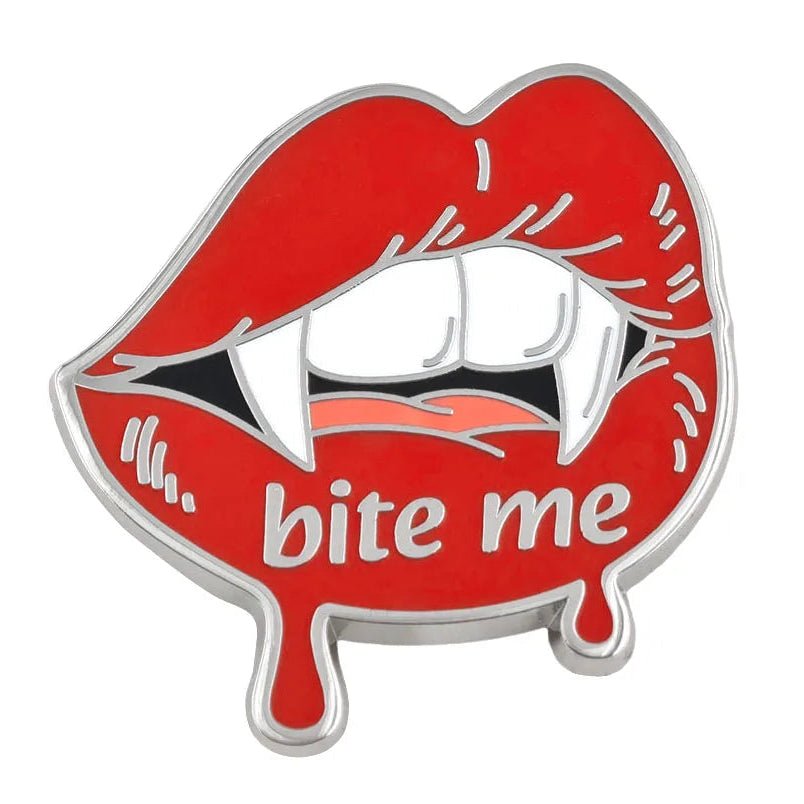 A vampire lips enamel pin featuring red lips with white fangs, black interior, and the words 'bite me' in white, outlined in silver metal.