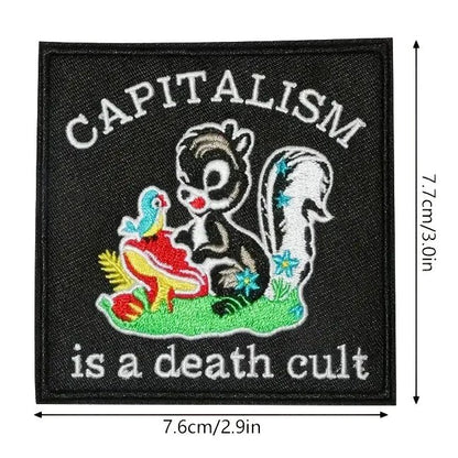 Patch with a skunk and text 'Capitalism is a death cult' 