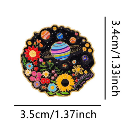 Pin with rainbow pride space-themed design featuring planets and flowers