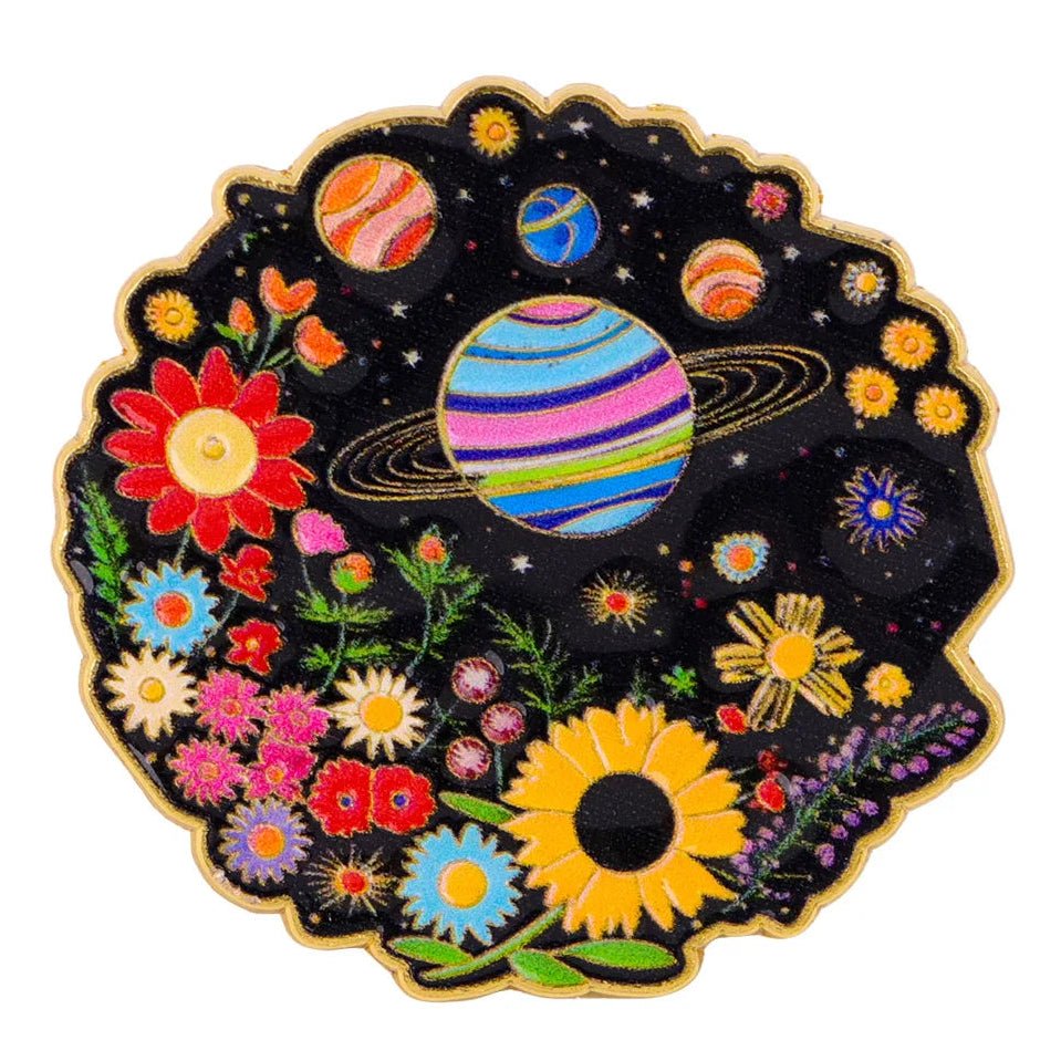 Pin with rainbow pride space-themed design featuring planets and flowers