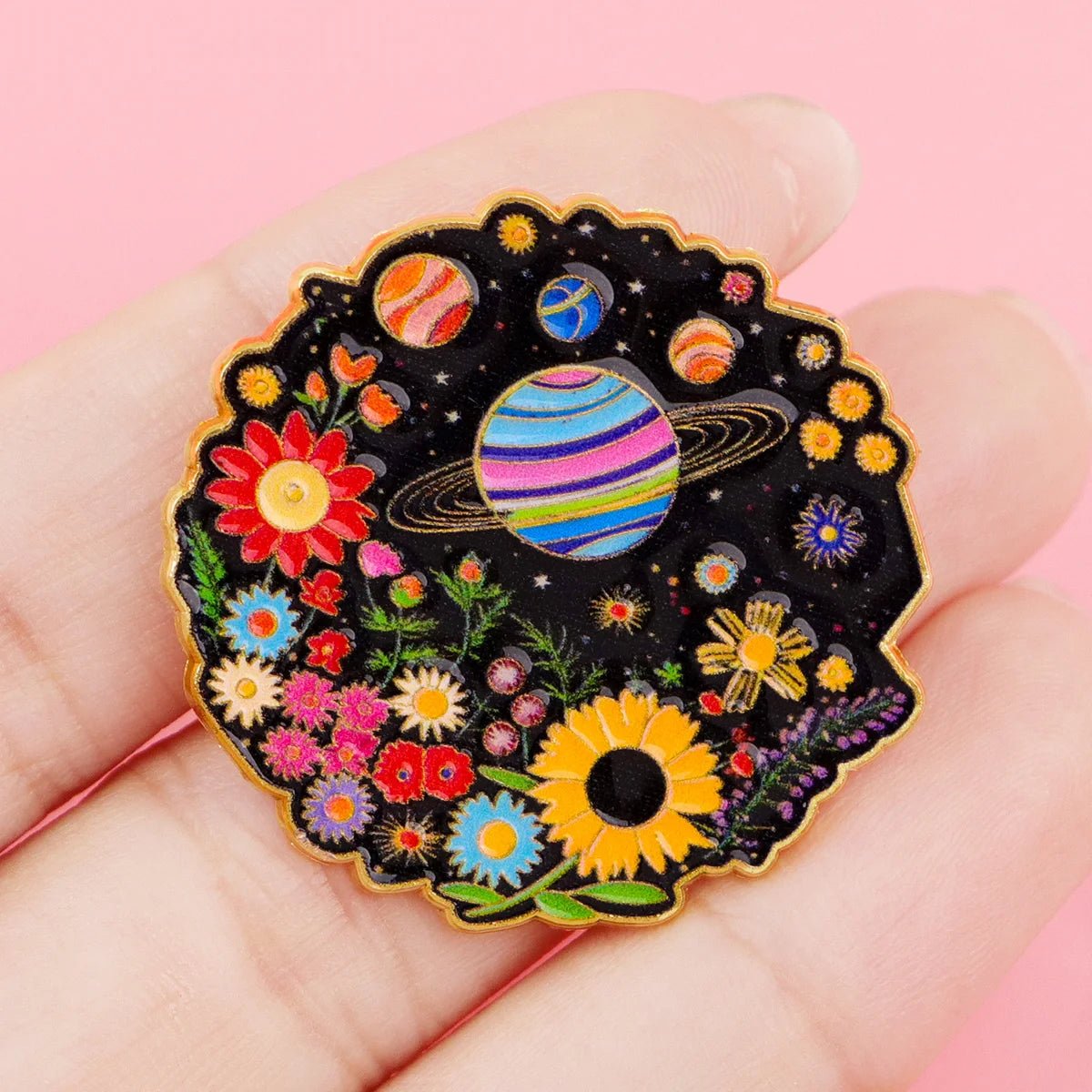 Pride Pin with rainbow space-themed design featuring planets and flowers