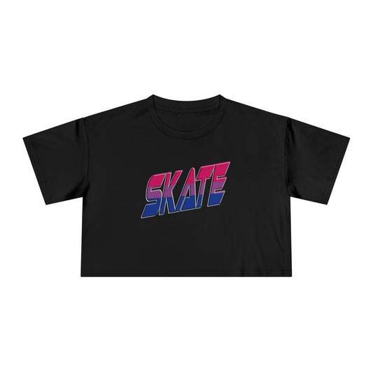 The "SKATE bisexual pride flag - locally printed crop tee" by Gay Skate is a black cropped T-shirt featuring the word "SKATE" printed across the front in a bold, gradient design that transitions from red at the top to pink, purple, and blue at the bottom. Perfect for Queer Skate events, it showcases text with a slightly 3D effect and a retro, angular font style.