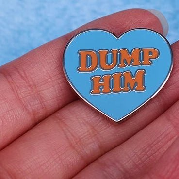 Blue love-heart shaped pin with 'Dump Him' text in red, inspired by Britney Spears