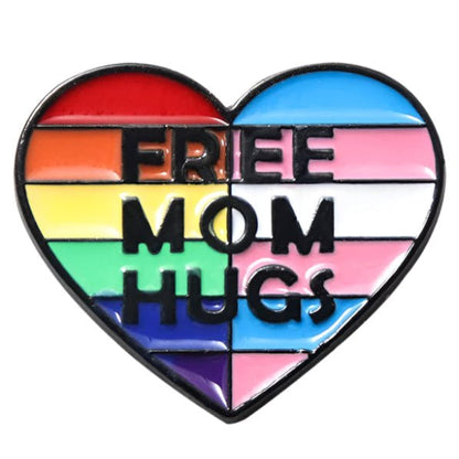 Free Mum Hugs heart shaped enamel pin badge featuring the rainbow and trans pride flag. Free mum hugs badge for allies