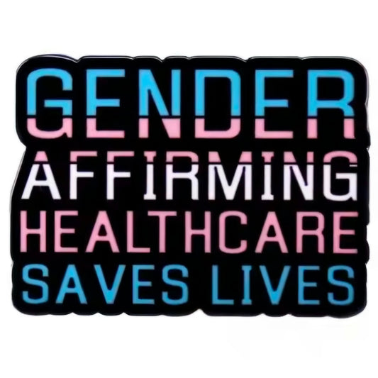 The Gender Affirming Healthcare Saves Lives - enamel pin features “Gender affirming healthcare saves lives” in blue, pink, and white text on a black background, with colors representing the transgender pride flag.
