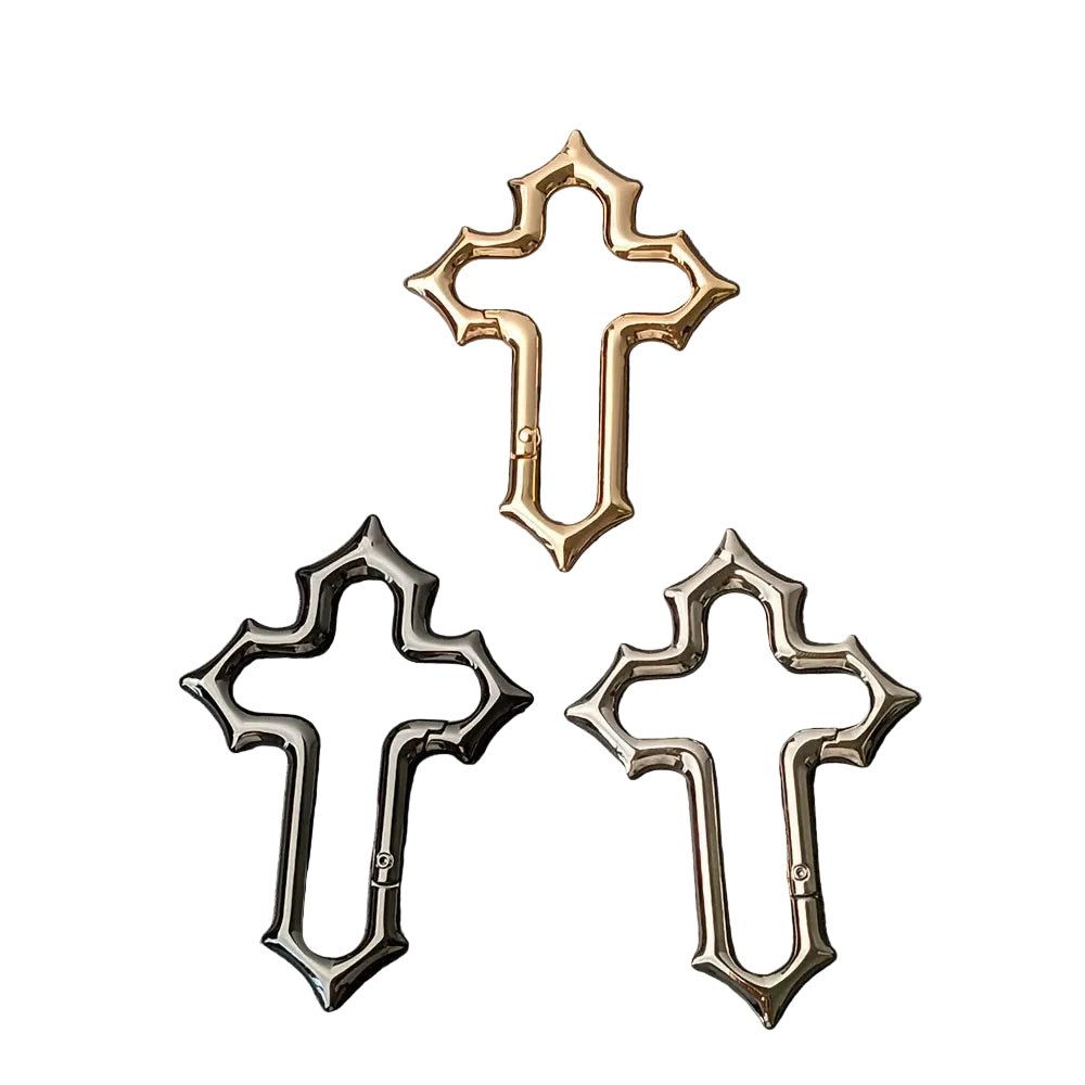 Gold, black and silver Gothic cross carabiners with pointed edges and side gates.