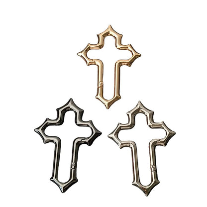 Gold, black and silver Gothic cross carabiners with pointed edges and side gates.