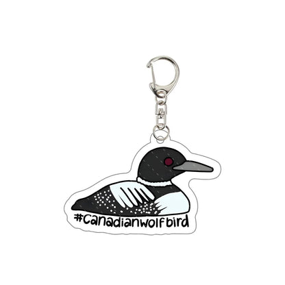 Keychain with a loon design and '#Canadianwolfbird' text 