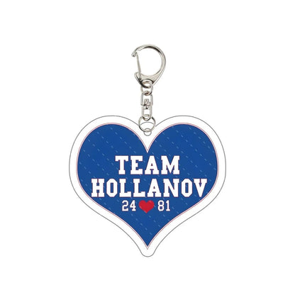 Heated Rivalry Heart-shaped keychain with 'Team Hollanov' 25 81 love heart text on a blue background