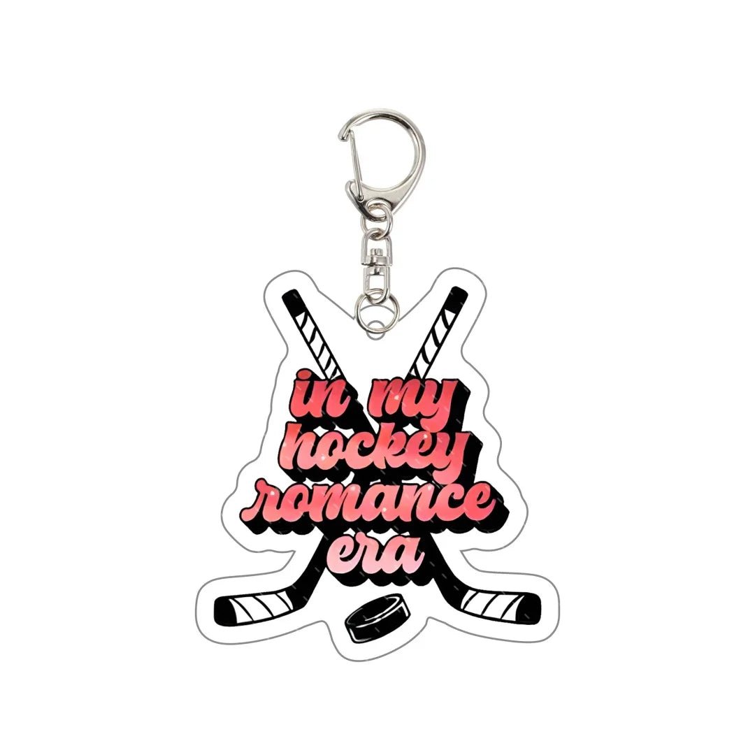 Keychain with crossed hockey sticks and text 'in my hockey romance era' 