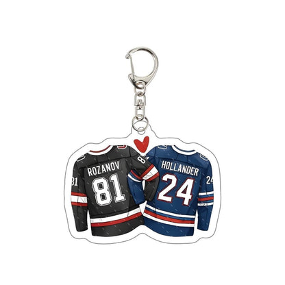 Keychain with two hockey jerseys, one black and one blue, featuring names and numbers Rozanov 81 and Hollander 24