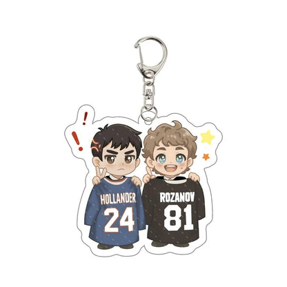 Heated Rivalry Keychain with cartoon characters wearing jerseys labeled 'Hollander' and 'Rozanov' 