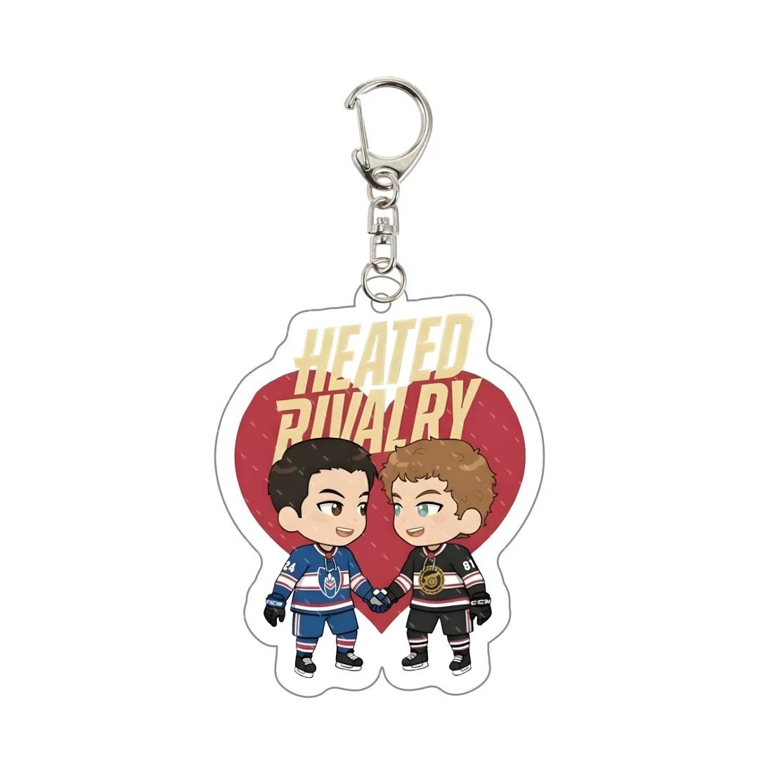 Keychain with cartoon characters holding hands and 'Heated Rivalry' text on a heart background.