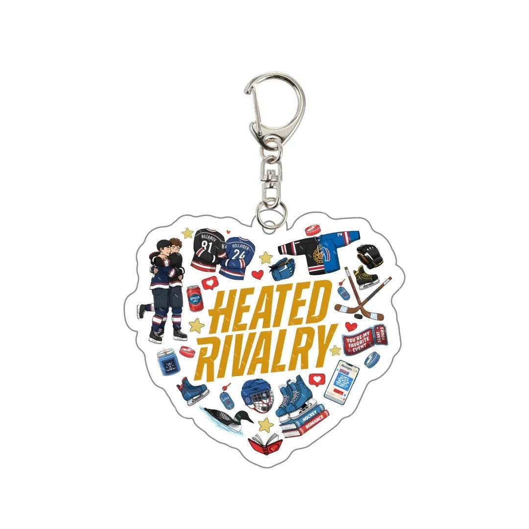 Heart-shaped keychain with hockey-themed illustrations and 'Heated Rivalry' text