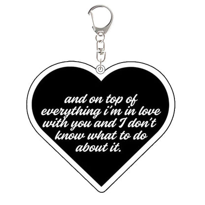 Heart-shaped Heated Rivalry  keychain with romantic text: and on top of everything i'm in love with you and I don't know what to do about it