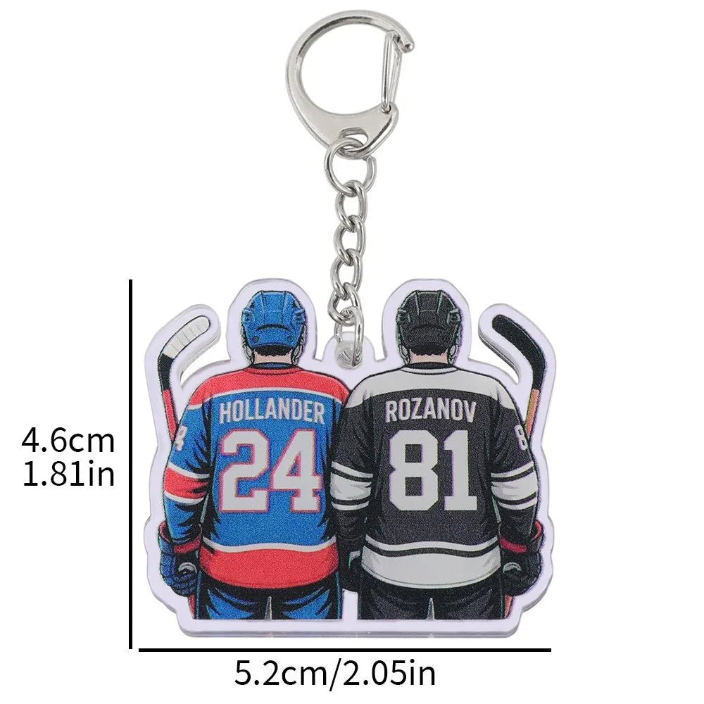 Heated Rivalry couple keychain with two hockey players in jerseys labeled Hollander and Rozanov