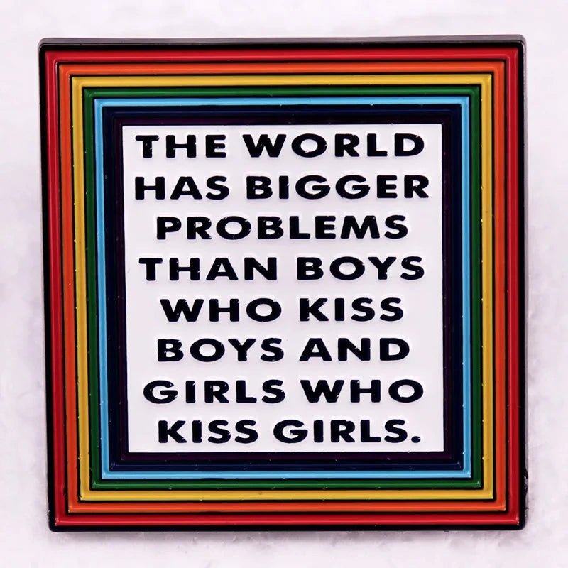 Pin with text 'The world has bigger problems than boys who kiss boys and girls who kiss girls' on a rainbow border.