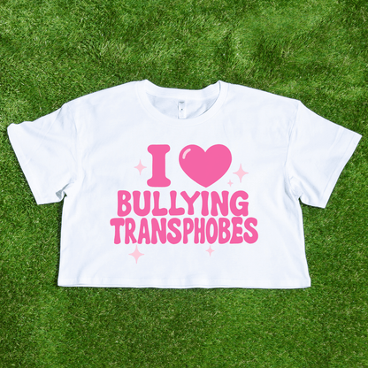 A statement crop tee reading "I 🩷 Bullying Transphobes," locally printed and perfect for queer streetwear lovers. Support a trans-owned small business with this bold piece—ideal for making your stance clear!.