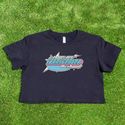 A black cropped tee from Gay Skate features a vibrant, retro-style text design that reads "Sounds Gay, I'm In" with "TRANSGENDER" boldly displayed in all caps underneath. Additional decorative elements like stars and a wavy line complete the look. Available as part of the "I LOVE MY TRANSGENDER GIRLFRIEND, BOYFRIEND, WIFE or HUSBAND" collection for Australian shipping.