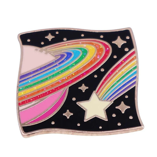 The Kiss Me Later enamel pin features a rainbow-striped Saturn and comet on a starry black background. This wavy square brooch adds a whimsical cosmic touch to your fashion accessories for a standout lgbt gay pride look.