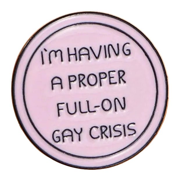 A round, light pink enamel pin titled "I'm Having A Proper Full-On Gay Crisis - Heated Rivalry," featuring the phrase "I'M HAVING A PROPER FULL-ON GAY CRISIS" in bold black capitals.