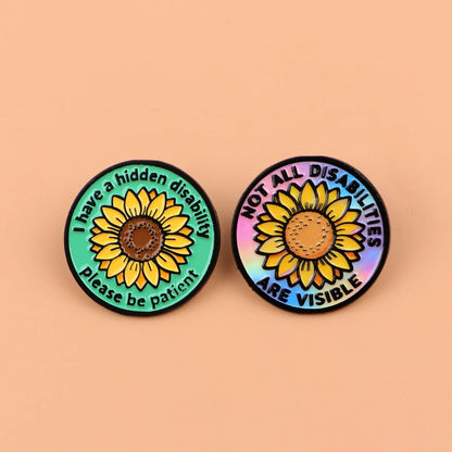 Two round pins with sunflower designs and Hidden Disability text. I have a hidden disability. Not all disabilities are visible