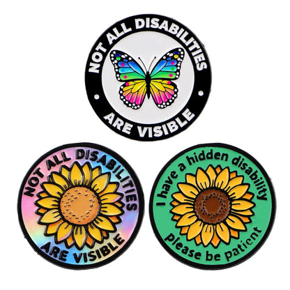 Three circular enamel pins with butterfly and sunflower designs, recognising hidden disabilities. Not all disabilities are visible. I have a hidden disability