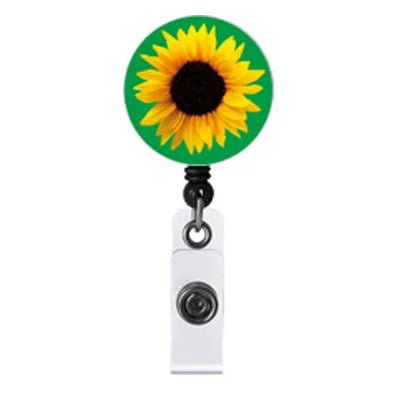 A retractable badge reel with Invisible Disability sunflower design on a green background, attached to a white clip on a plain white background.