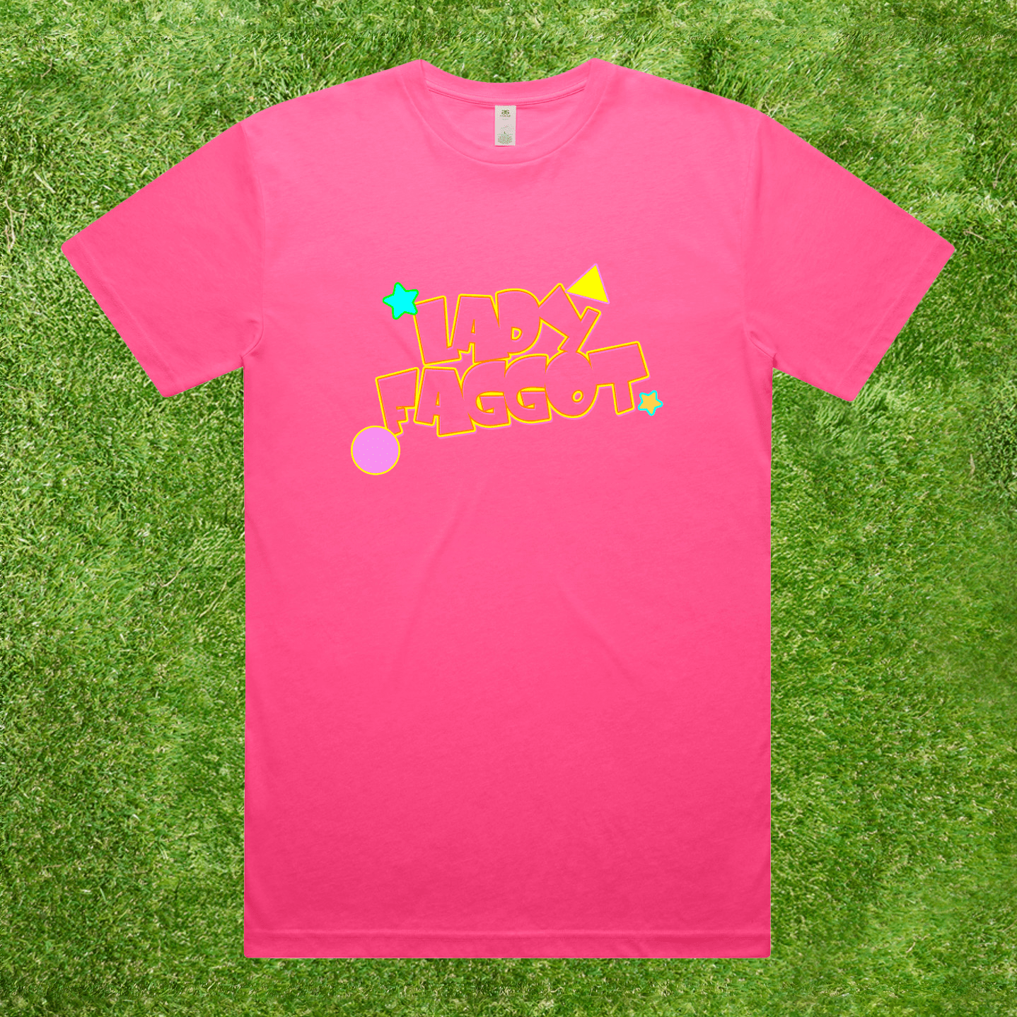 A bright pink short-sleeve t-shirt with a colorful retro-style graphic reading 'LADY FAGGOT' in yellow outline letters with stars and circles