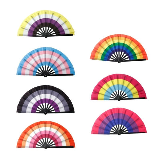 An image features Very Large Folding Persinal Fans from Gay Skate, each representing different pride flag identities. The colors are vibrant rainbow spectrums, with each fan displaying a unique design reflecting the Rainbow, Lesbian, Bi, Trans, Non-binary, Pansexual, and Asexual pride flags.  Drag queen fans