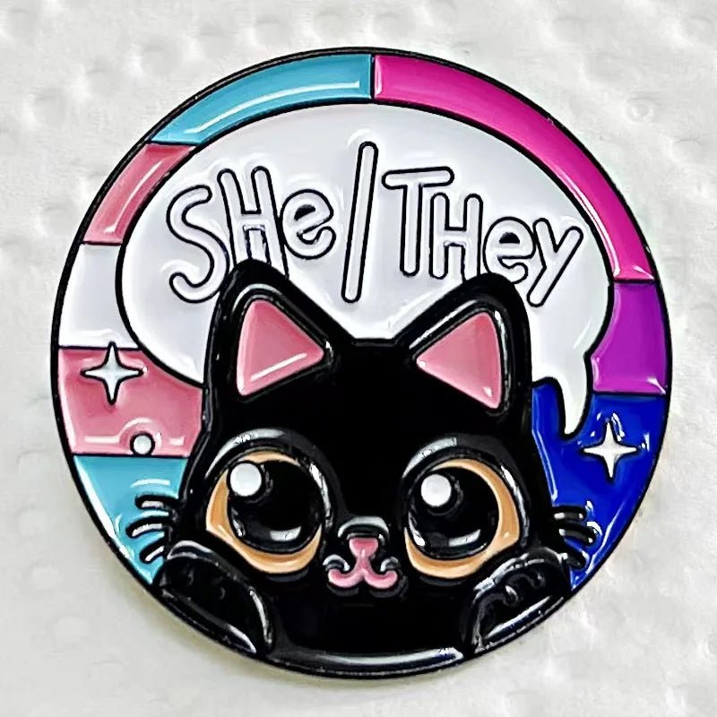 She/They pronoun badge with trans pride and bisexual pride flag cat badge