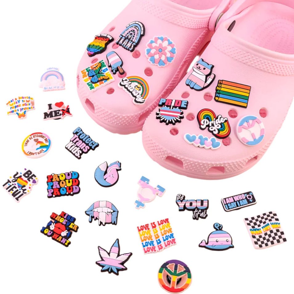 LGBTIQA Shoe Jibbitz, sets of crocs clogs shoe charms  designed to enhance your Crocs. These vibrant accessories feature colorful LGBT themed designs such as rainbows and pride flags. Additionally, you can personalize your footwear with charms that spell out empowering messages like "Pride" and "Love is Love. 