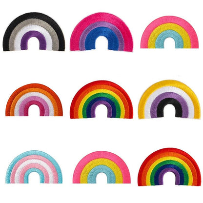 A collection of nine uniquely colored LGBTIQAP+ Pride Embroidered Iron-On Patches from Gay Skate, arranged in three rows. Each half-circle patch showcases a distinct rainbow pattern and color combination, celebrating LGBTQ pride flags with intricate and vibrant designs.