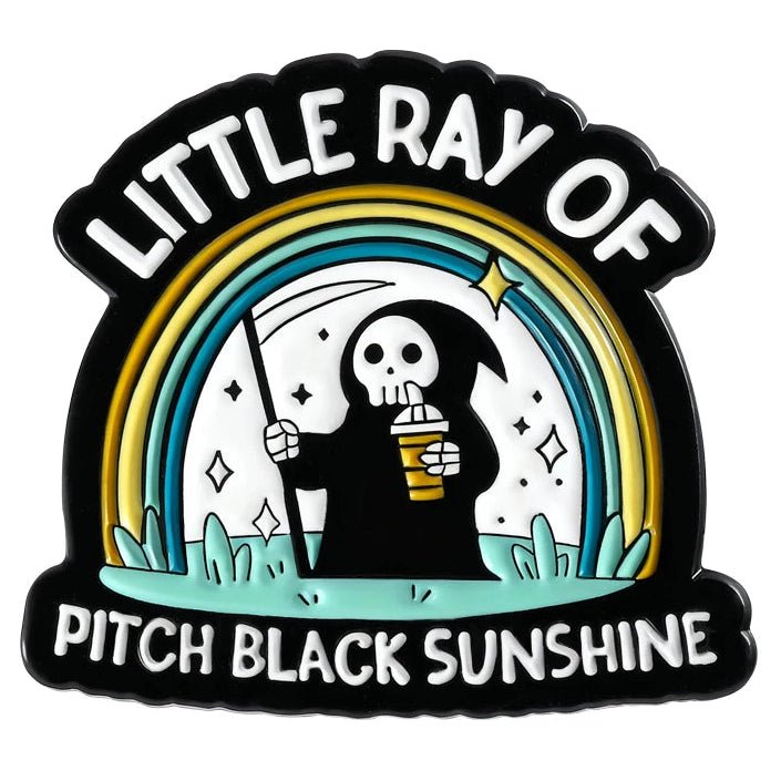Emo Enamel pin with a design of a skeleton holding a coffee cup and rainbow, labeled 'Little Ray of Pitch Black Sunshine'.