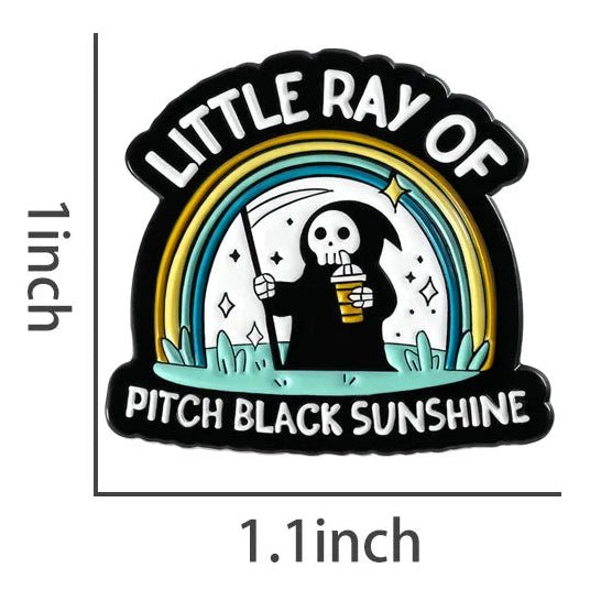 Emo Enamel pin with a design of a skeleton holding a coffee cup and rainbow, labeled 'Little Ray of Pitch Black Sunshine'.