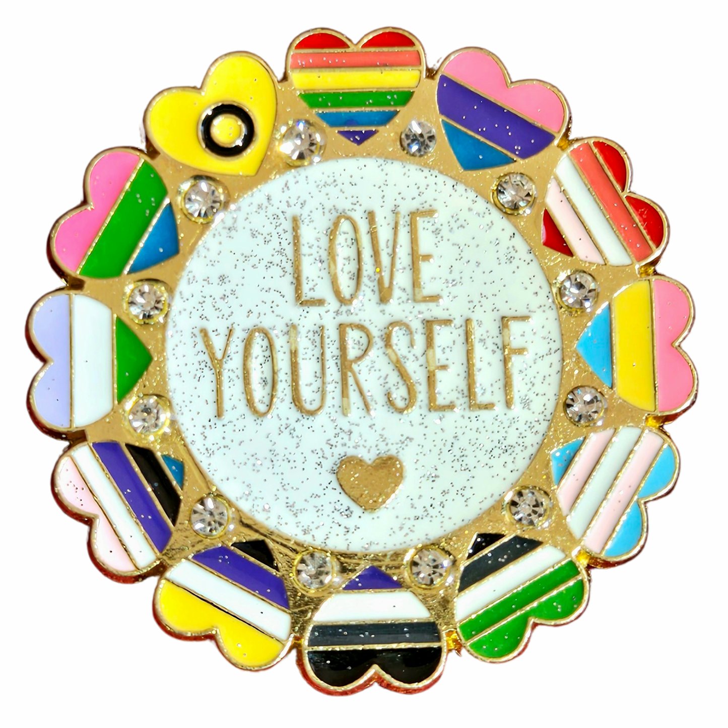 The “Love Yourself - ultra pride enamel pin” is a circular enamel pin with "LOVE YOURSELF" in gold at the center, surrounded by heart shapes in LGBTQ+ pride flag colors and sparkling gems.