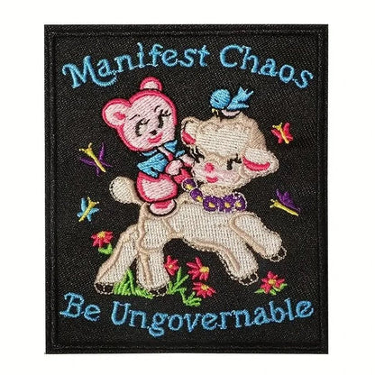 Embroidered patch with a bear and lamb design and text 'Manifest Chaos Be Ungovernable' on a black background.