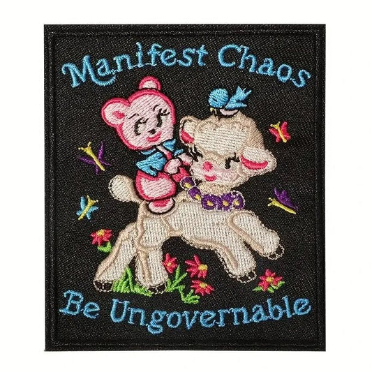 Embroidered patch with a bear and lamb design and text 'Manifest Chaos Be Ungovernable' on a black background.