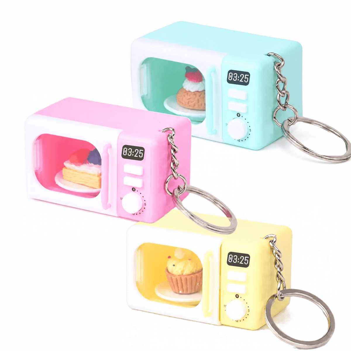 Three Mini Microwave Keychain with Light & Sound - Cute Kitchen Bag Charm keychains in pastel pink, light blue, and yellow, each containing a tiny food item and displaying “03:25” on the digital clock.