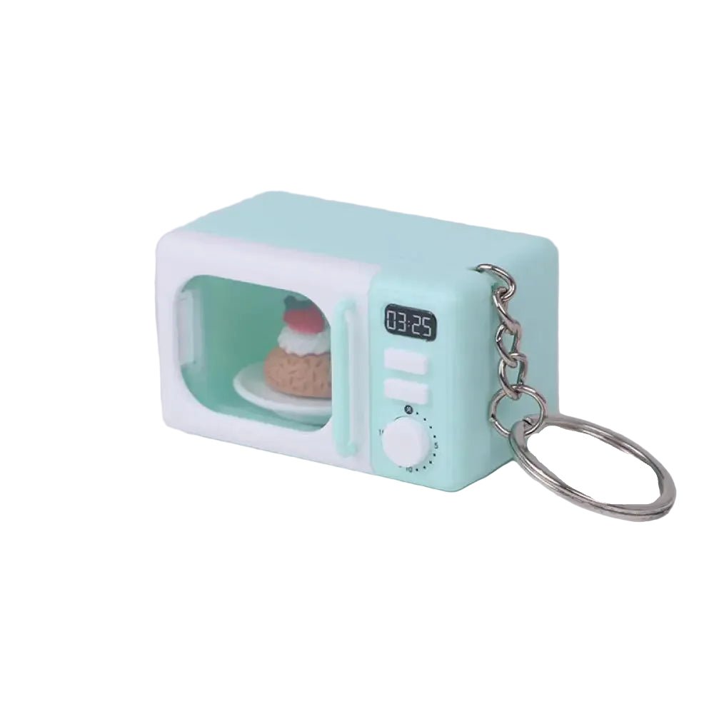 A mint green and white miniature microwave keychain with a small digital display and a metal key ring